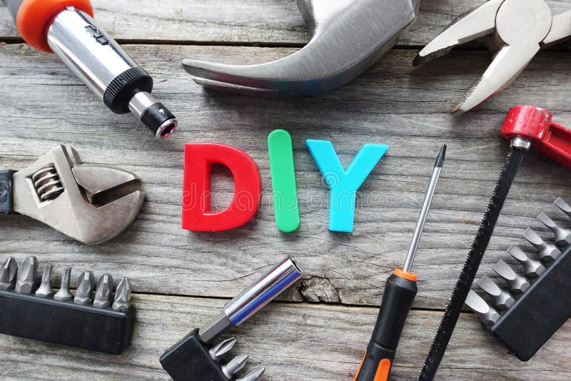 Do it yourself concept with DIY acronym from plastic letters in the middle of tools prepared for work royalty free stock images